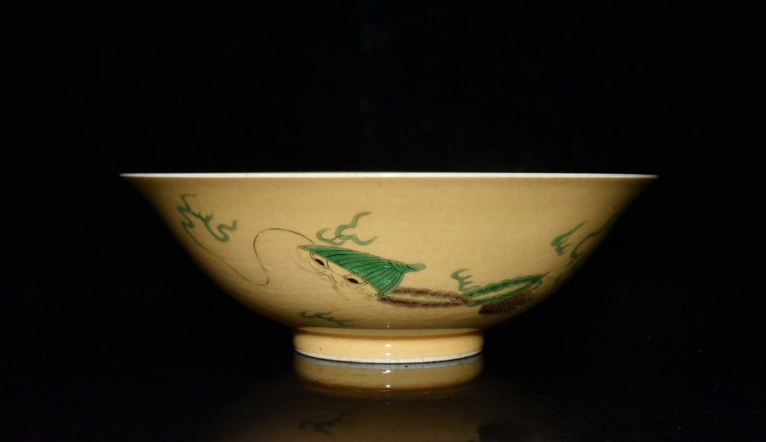Kangxi period Qing dynasty rice-yellow glazed plain sancai (three-color) bowl with cloud and dragon: A Qing Dynasty Kangxi period rice-yellow glazed plain sancai (three-color) bowl with cloud and dragon design, decorated with enamels on an aged body, 7.5 x 22.3 cm. Provenance:Private Estate, Michigan