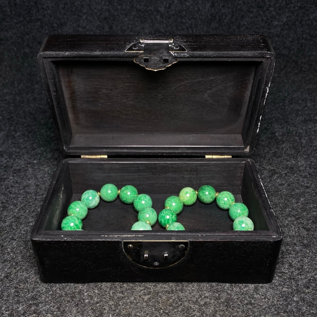 A precious jade bracelet is housed inside an exquisite ebony jewelry box inlaid with jade.: A precious jade bracelet is housed inside an exquisite ebony jewelry box inlaid with jade. Provenance:Private collection from a professor in Harvard University. Our dedicated team expertly handles bot