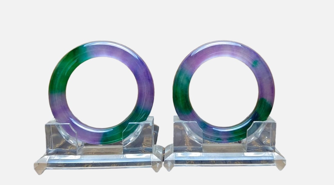 A pair of top-grade dragon stone type multicolored jadeite bangles: A pair of top-grade dragon stone jadeite bracelets, with excellent translucency and absolutely perfect quality. Provenance:Mr.Jordi, Northern Virginia. Our dedicated team expertly handles both domesti