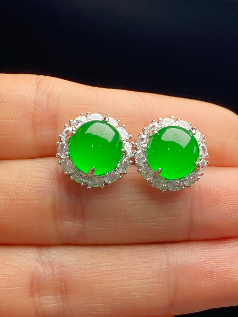 Jadeite earrings with a full green, icy texture.: Jadeite earrings, icy green, translucent and lustrous, exquisitely three-dimensional, and flawlessly flawless. Provenance:Mrs. Blair, Newport Beach, California. Our dedicated team expertly handles bot
