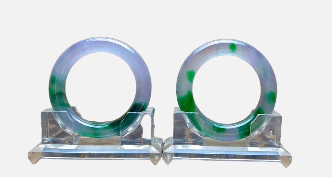 A pair of top-grade dragon stone jadeite bracelets with spring colors: A pair of top-grade dragon stone jadeite bangles with spring colors, excellent translucency, absolutely perfect. Provenance:Private collection, Quincy, Massachusetts. Our dedicated team expertly handl