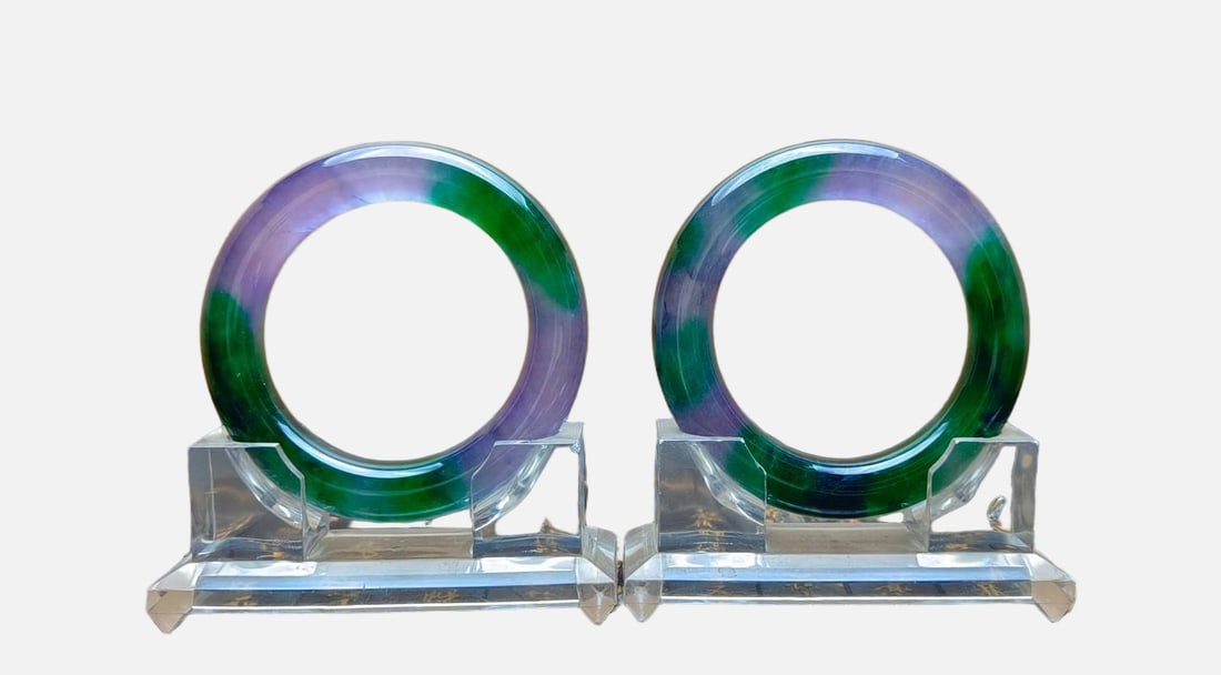 A pair of jadeite bangles with spring colors from dragon stone: A pair of jadeite bangles with spring-like colors from the dragon stone variety; excellent translucency and absolutely perfect. Provenance:Private Estate, Honolulu, Hawaii. Our dedicated team expertly