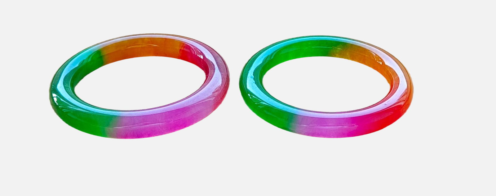 A pair of top-grade dragon stone type multicolored jadeite bangles: A pair of top-grade dragon stone jadeite bracelets, with excellent translucency and absolutely perfect quality. Provenance:From a private collection in San Diego, California, USA. Our dedicated team e