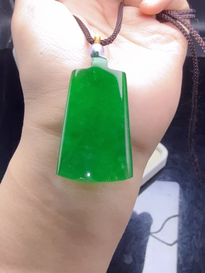 A jadeite pendant of icy green color, symbolizing peace and safety. (1 of 9)