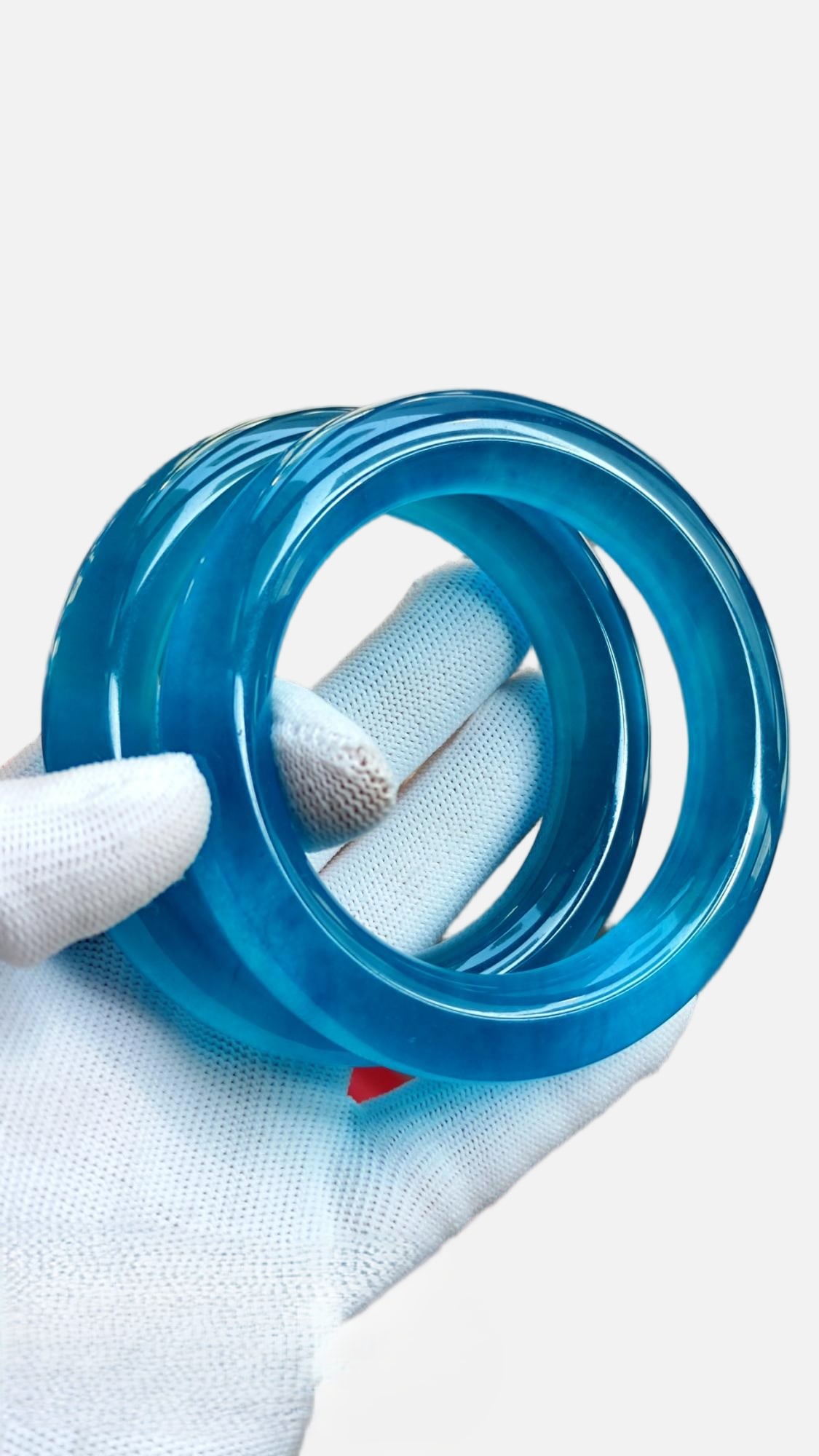 A pair of high-ice jadeite bangles, and a blue jadeite bangle. (1 of 7)