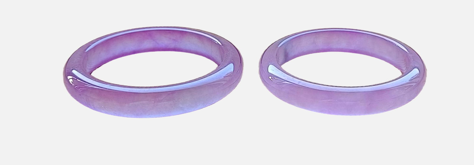 A pair of dragon-stone type violet flat jadeite bracelets: A pair of dragon-stone type violet flat jadeite bracelets, with excellent translucency. Provenance:Private collection from a professor in University of Pennsylvania. Our dedicated team expertly