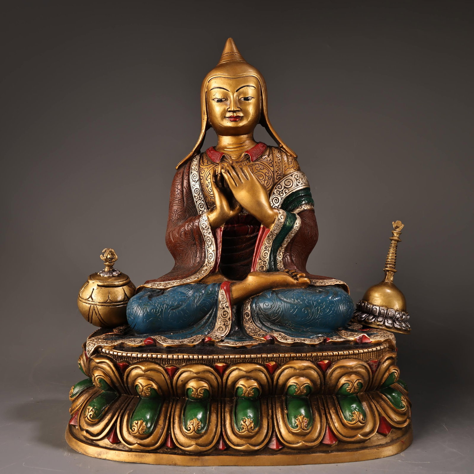 A Tibetan-style Atisha Buddha statue, crafted entirely from pure copper with high relief engraving: This is a Tibetan Atisha Buddha statue made of pure copper with high relief engraving and gilding. It is exquisitely crafted and beautifully made. It weighs 3900 grams, is 34 cm high and 29 cm wide. P