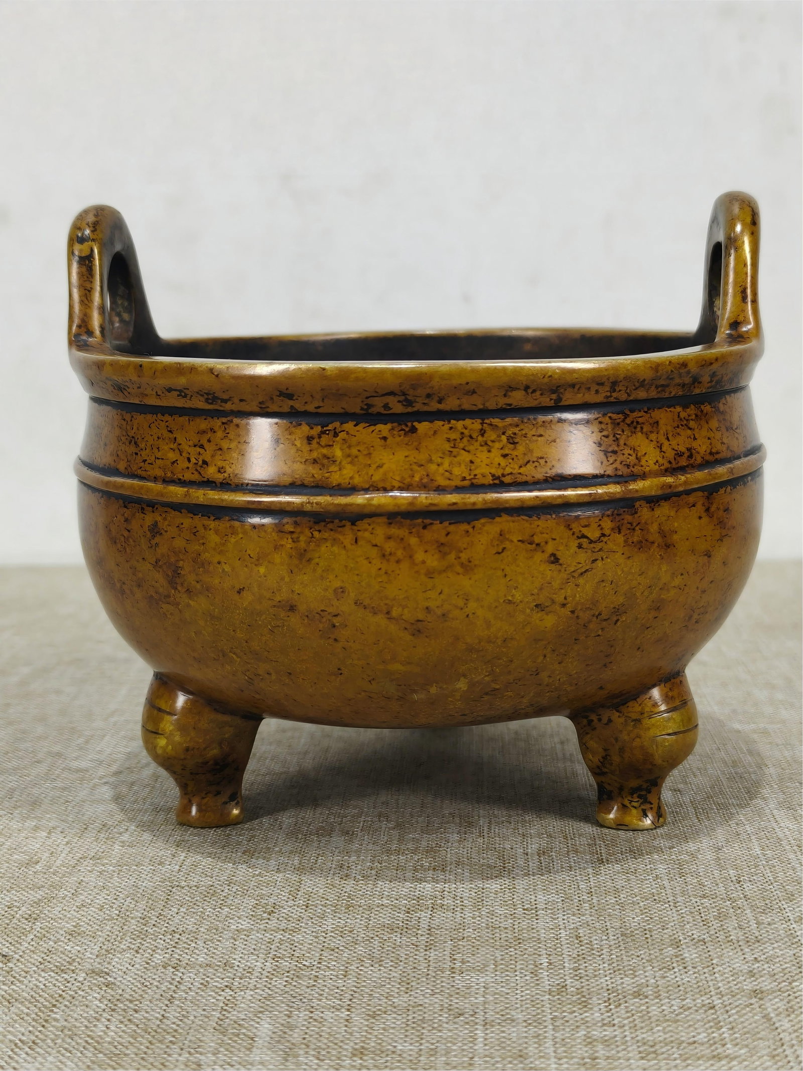 A rare Ming Dynasty Xuande period three-legged bronze incense burner with a bottom mark. (1 of 7)