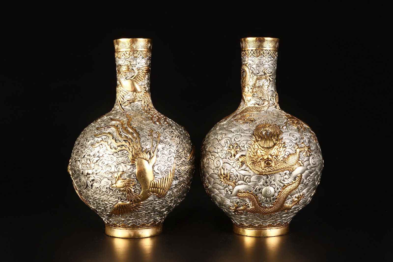 A Qing Dynasty bronze vase with partial gold and silver dragon and phoenix decoration, formerly in (1 of 9)