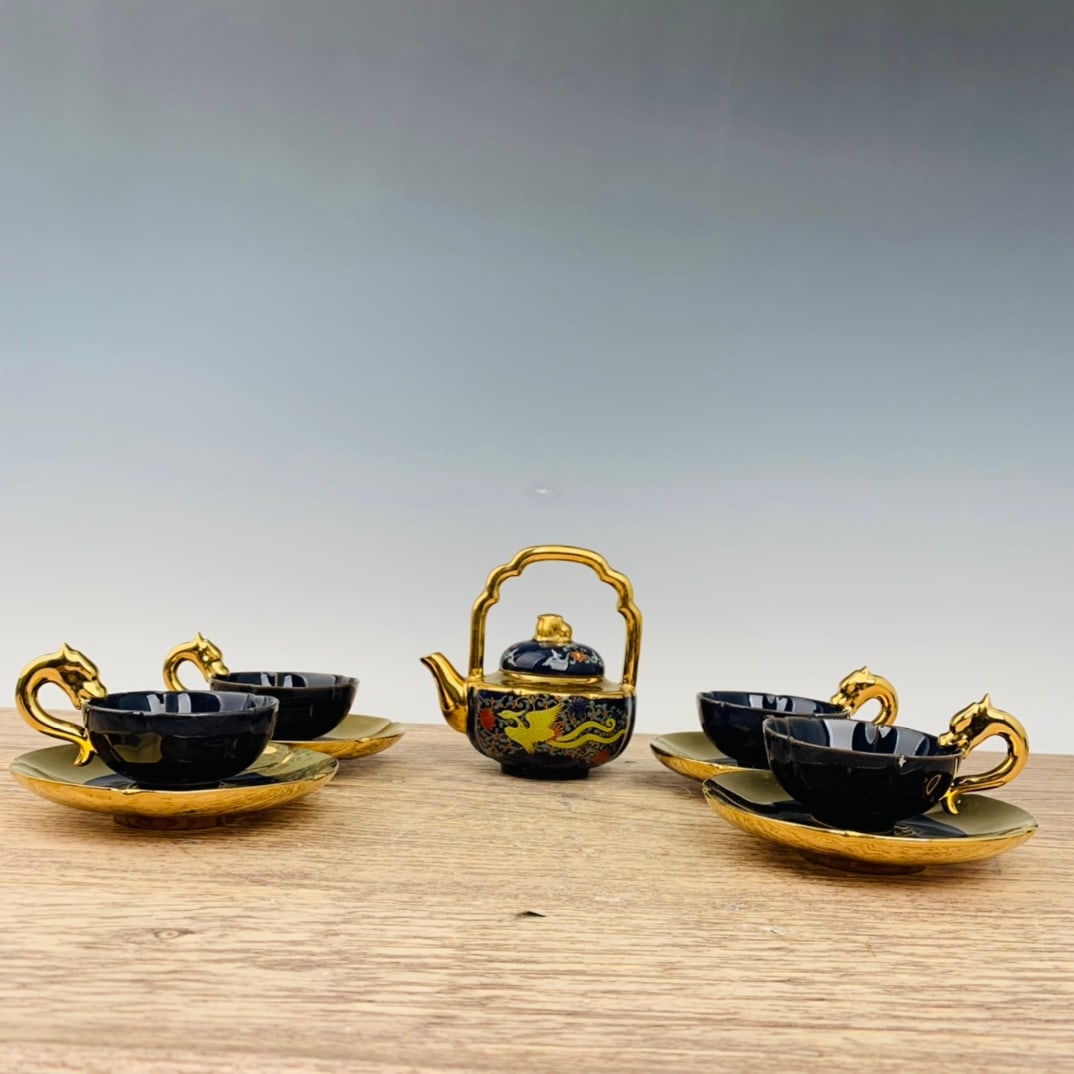 Ru porcelain gilt and polychrome tea set with a teapot, four saucers, and cups.: Ru ware, gilded and decorated, a tea set with a pot and four saucers, 14 cm high, 13 cm in diameter, and saucers 8 x 12.5 cm high. Provenance:Private collection from a professor in Harvard University.