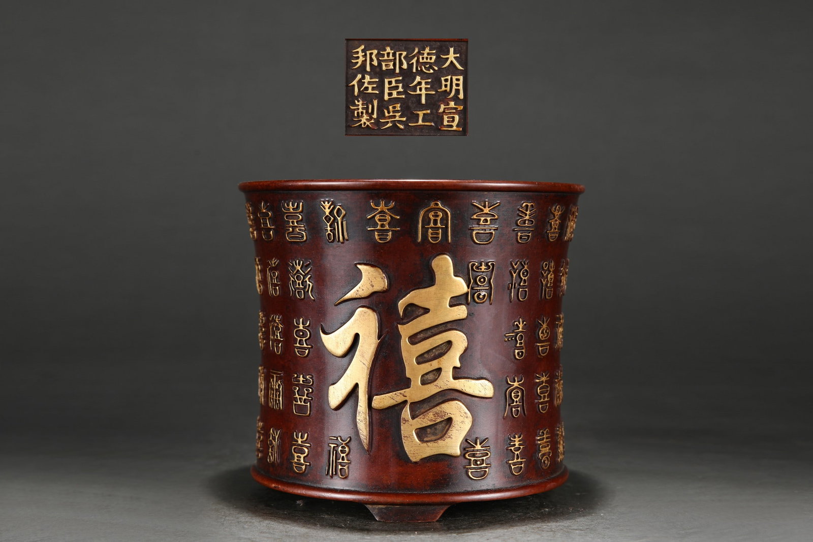 Ming Dynasty Gold Hundred Happiness Pattern Brush Pot: This Ming Dynasty gold-plated brush pot with a hundred-happiness motif measures 13.8cm in height, 15.6cm in diameter, and weighs 3100g. The inscription reads "Made by Wu Bangzuo, Minister of Works, du