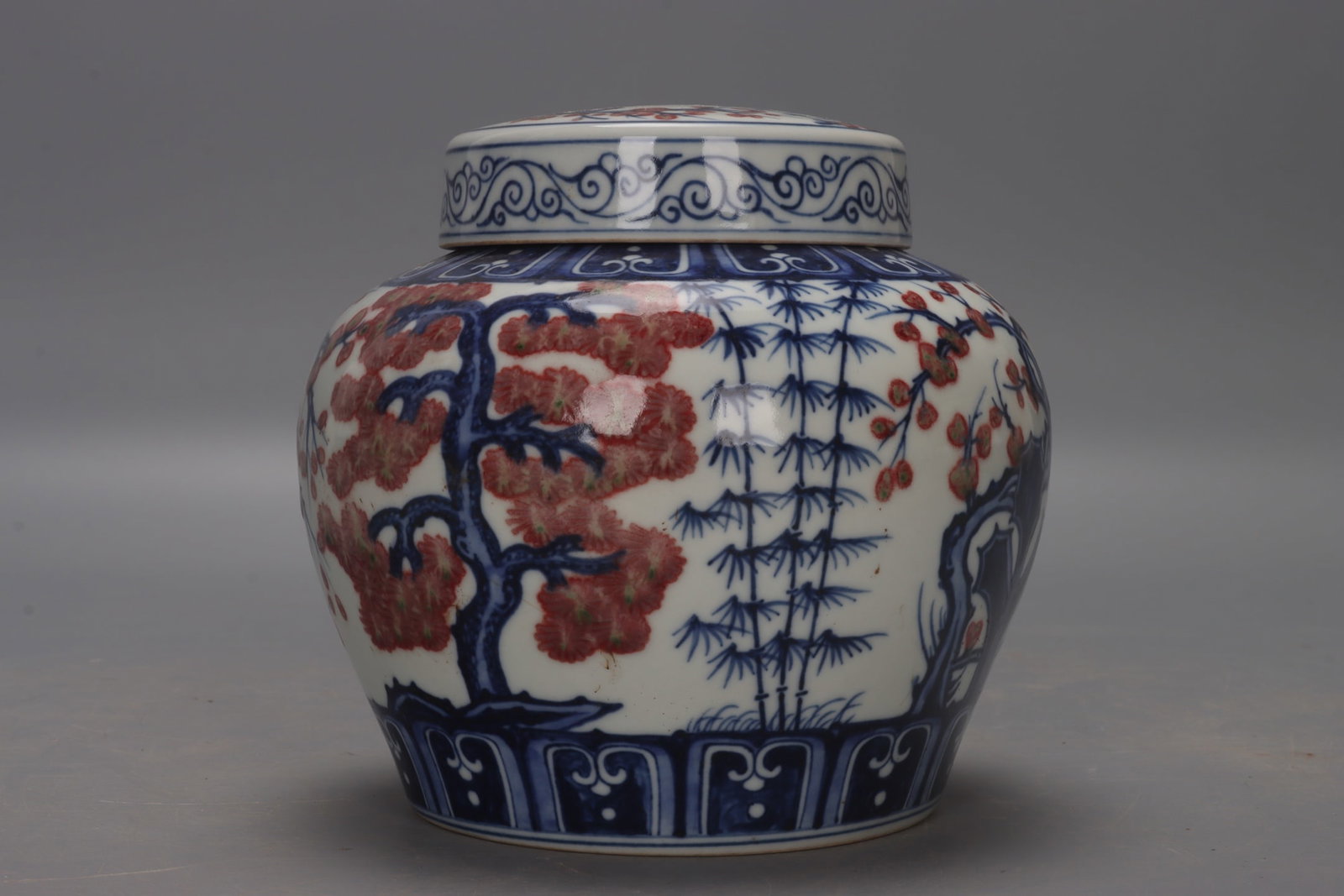 A Ming Dynasty Xuande period blue and white underglaze red pine, bamboo and plum blossom jar with: A Ming Dynasty Xuande period blue and white underglaze red pine, bamboo and plum blossom jar with the character "??" (tian), measuring 13 cm in height, 7.5 cm in mouth diameter, 13.5 cm in belly diame