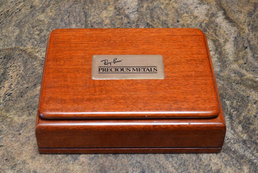 Ray Ban Sunglasses Store Wooden Box: Wonderful Ray-Ban box, marked Made in Peru on the bottom, which shows Ray-Ban and their Precious Metals Line of upscale Sunglasses. Either given along with the $500 pair of Sunglasses, or used in the 
