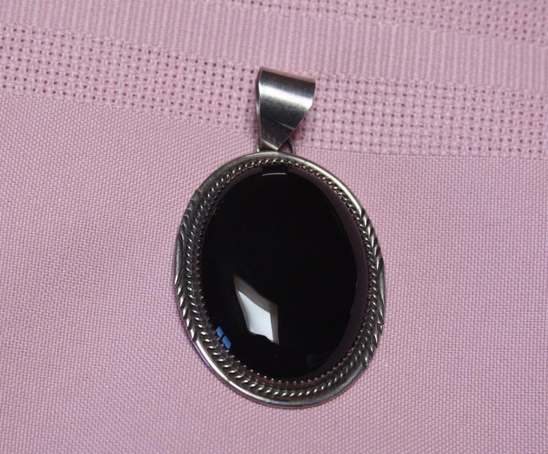 Native American Navajo Onyx and Sterling Pendant: Signed L and marked Sterling Pendant, 2.25" by 1.25", nice stone, fantastic silversmith work, will ship using Priority Mail and only charge $8 with tracking