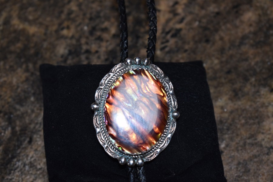 Navajo Bolo Tie, Signed JJ, Pieterside stone: Interesting Navajo Bolo Tie, measuring 37", bolo has an unusual stone, told Pietersite, signed JJ for James Jefferson, Bolo is 1 1/2" by 2", tips are sterling. Shipping is $12. Beautiful Bolo!