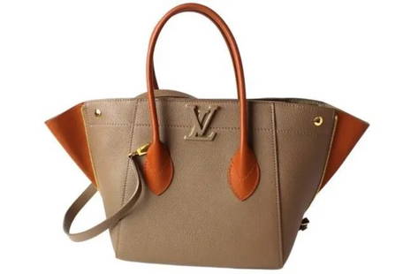 LOUIS VUITTON Calfskin Limited Edition Beige Purse Bag | Made in France 2017: LV the Freedom collection bag features top handles with two lateral zips on the side. The zips give extra space to the bag, which is perfect for everyday use. The bags come with a leather-and-metal LV