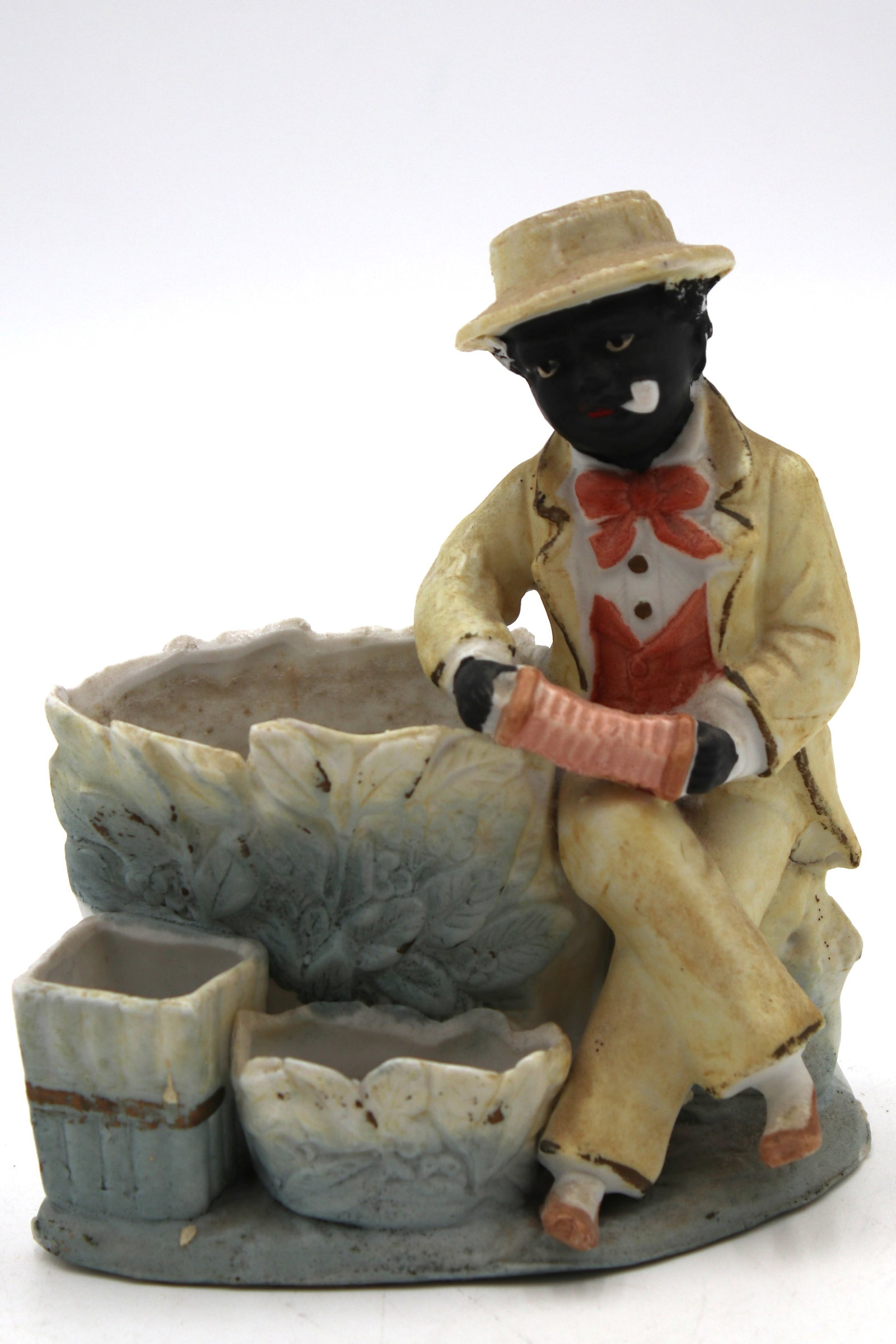 Blue Vintage C. 1930 Black Americana Man Sitting With Accordion Cigarette, Match Holder And Ashtray: Blue Vintage C. 1930 Black Americana Man Sitting With Accordion Cigarette, Match Holder And Ashtray Figurine. This vintage c. 1930 Black Americana figurine depicts a charming scene of a seated man pla