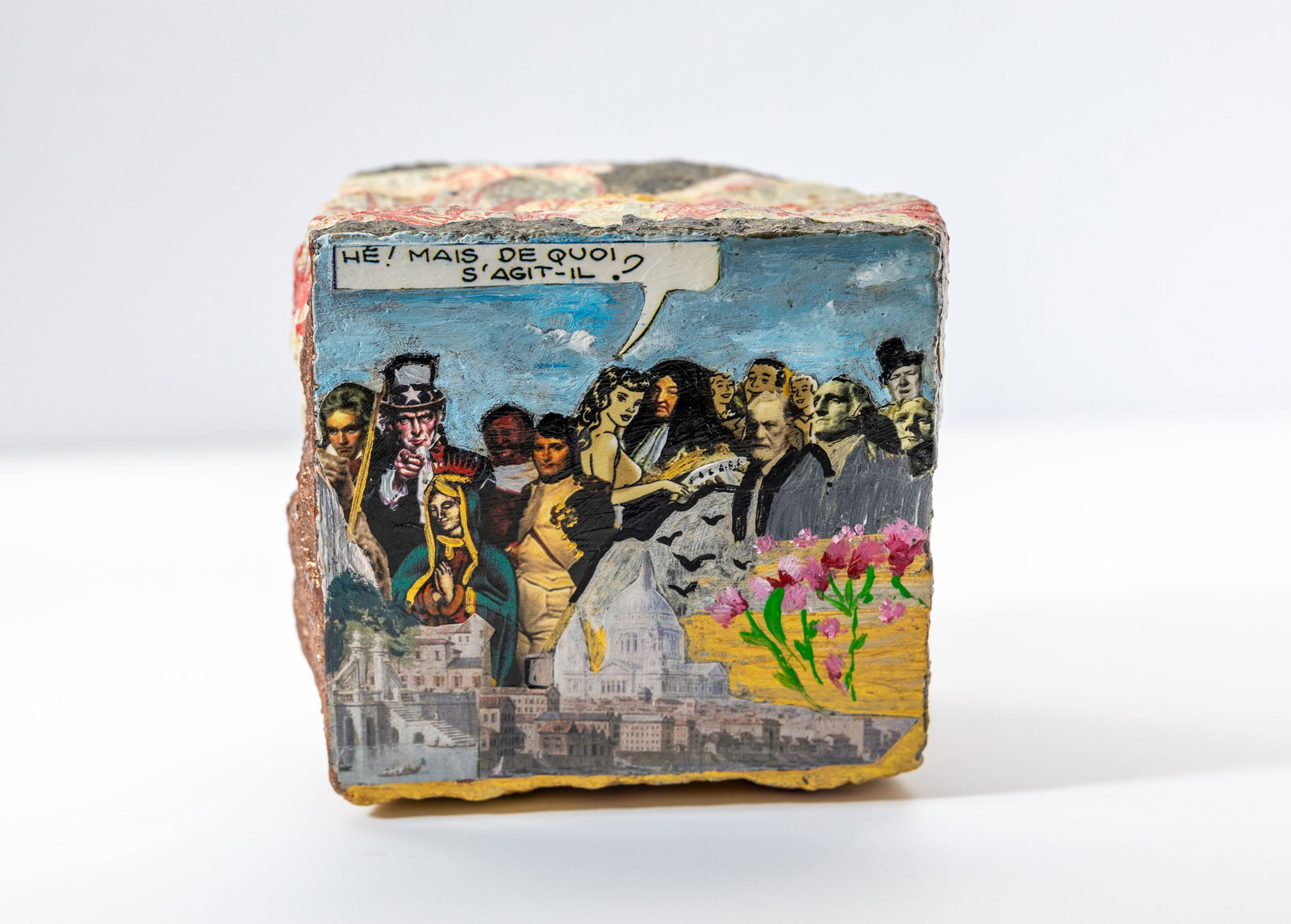 N. ZELMAN. PAINTED BRICK: Description:N. Zelman, This is a painted brick featuring a surreal collage of historical and fictional characters, a French speech bubble, and a cityscape at the bottom. Material:Oil, Acrylic Measurme