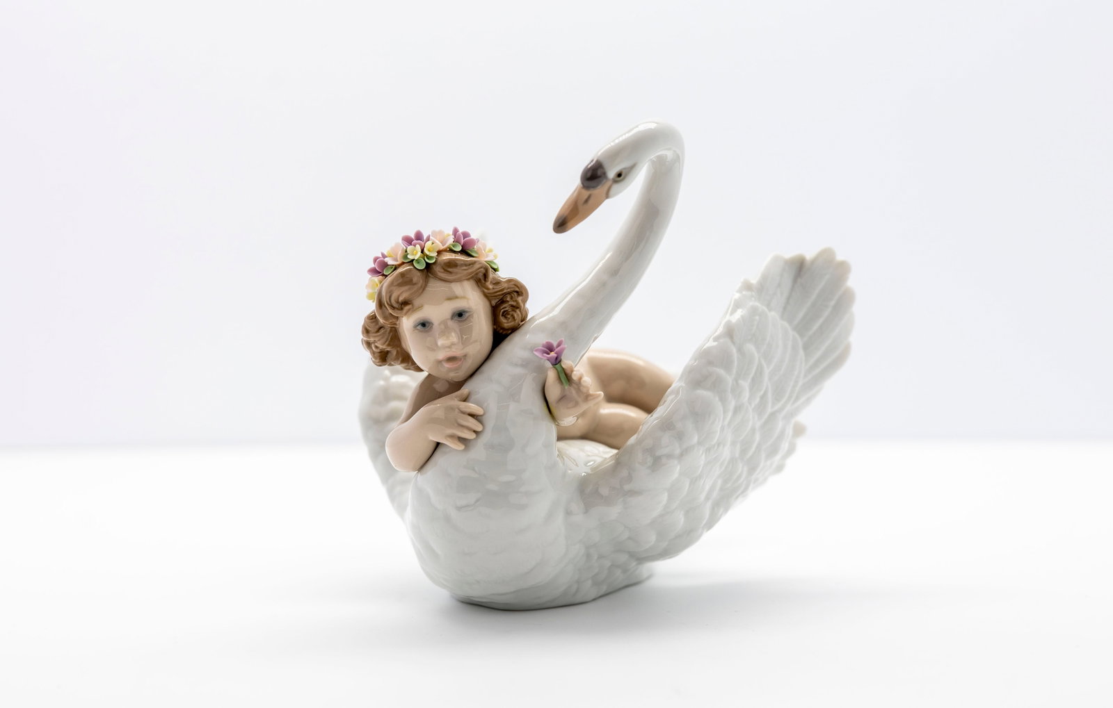 LLADRO "MY MAGICAL SWAN": Title: "MY MAGICAL SWAN" by Lladro. Artist: Sculpted by Regino Torrijos. Description: Captures a tender moment of serenity, innocence, and wonder. The delicate porcelain figurine capture