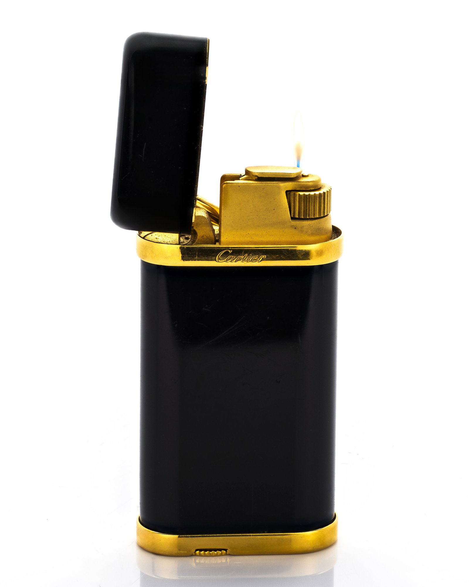 Cartier Black & Gold Lighter: Title: Cartier Black and Gold Butane Lighter Origin: Switzerland Material: Black lacquer with gold-plated metal Serial Number: 317839 Dimensions:</