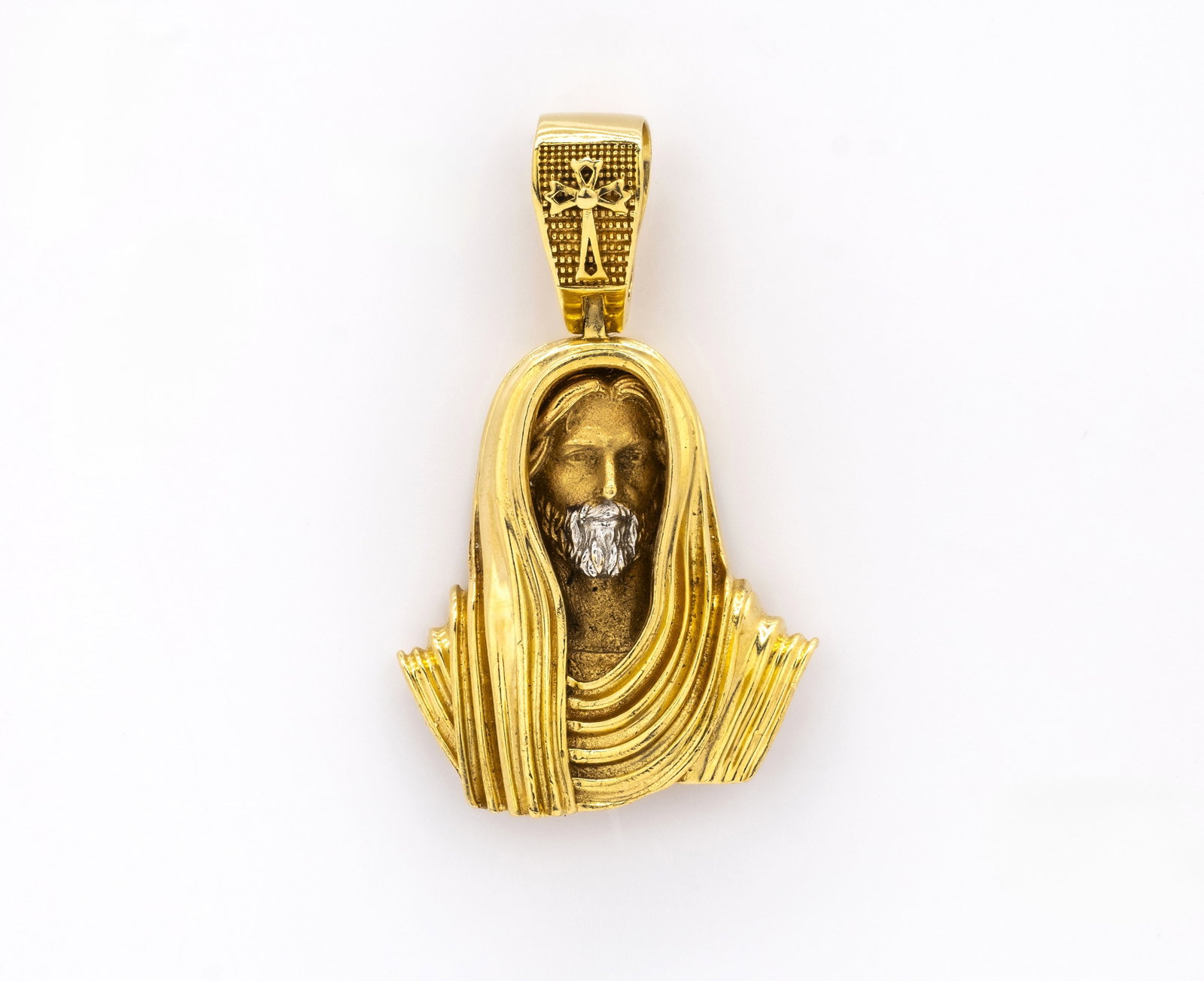 Yellow and White Gold Jesus Bust Pendant: Title: Yellow and White Gold Jesus Bust Pendant Description: A finely detailed religious pendant depicting the bust of Jesus Christ, crafted in 18K yellow gold with white gol