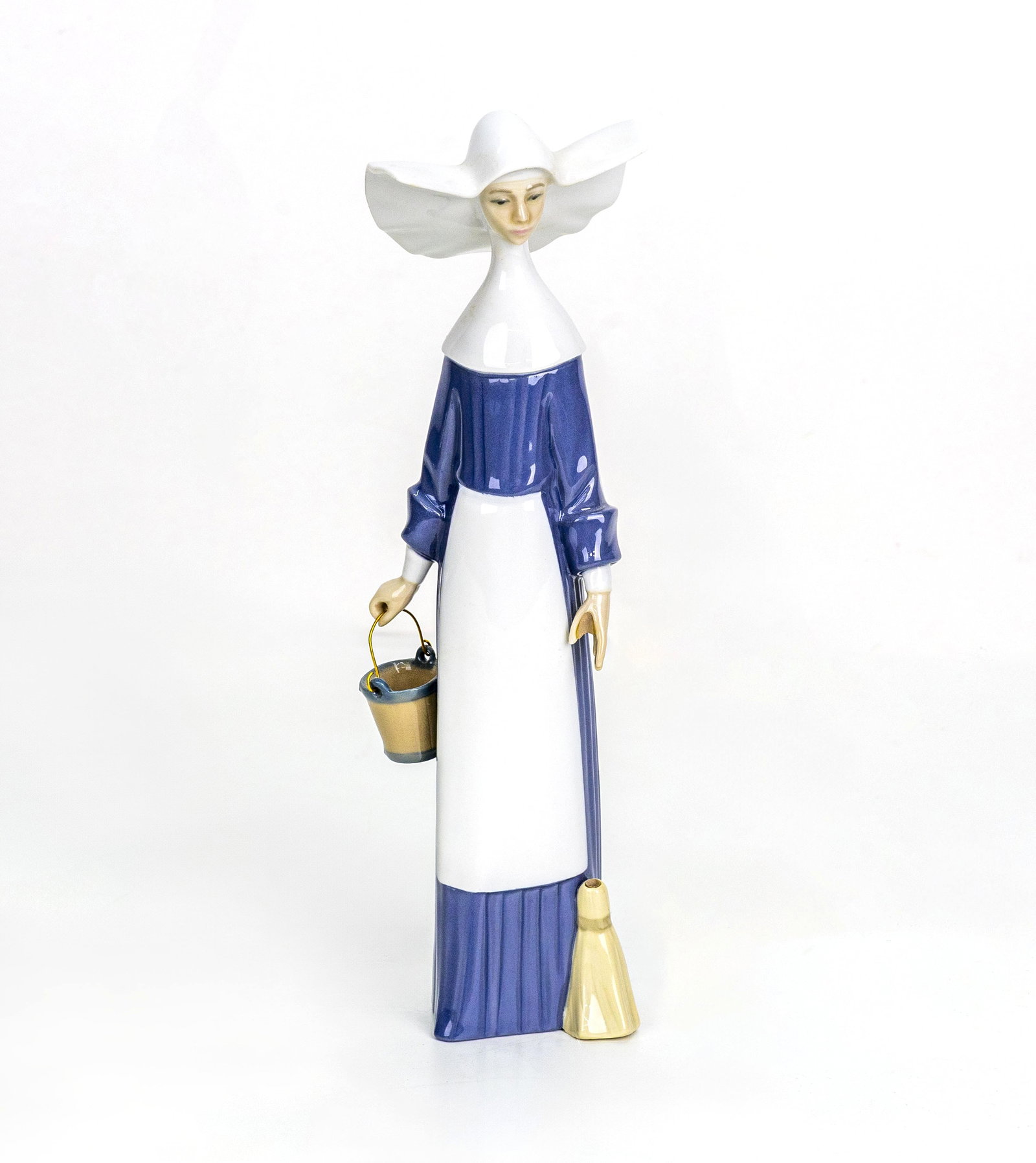 Lladro, Spain, Nun with Bucket, Model No. 5552: Artist, Year, Title: Lladro (Spain), Nun with Bucket, Model No. 5552, 20th Century Origin: Valencia, Spain Medium: Glazed porcelain