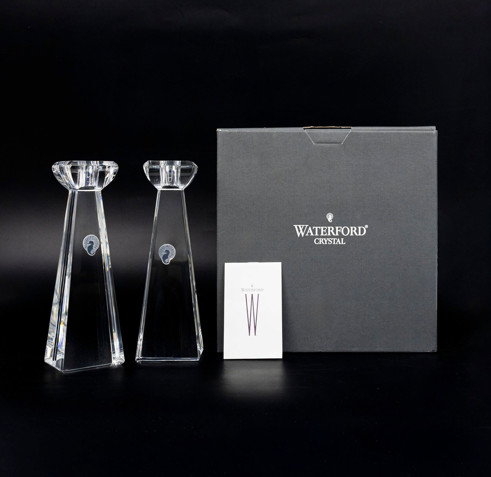 Waterford Crystal Pair of Candlesticks: Title: Waterford Crystal Pair of Candlesticks 8¼ in (21 cm) Height: 8¼ in (21 cm) Shape: Elongated rectangular pyramid Material: Fine hand-cu