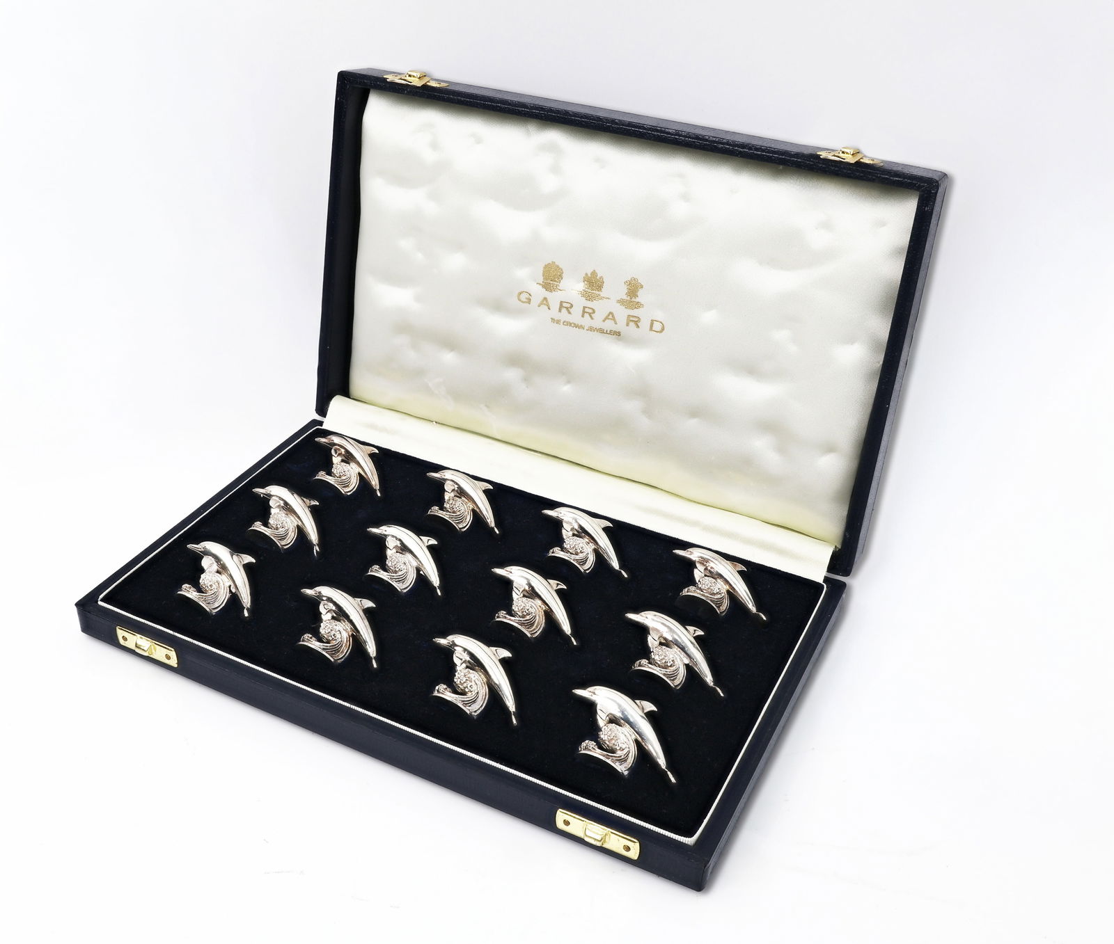 Garrard Set of 12 Silver Dolphin-Shaped Figures: Title: Garrard Set of 12 Silver Dolphin-Shaped Figures Maker: Garrard Crown Jeweller Origin: United Kingdom Materials: Silver Quantity: Se