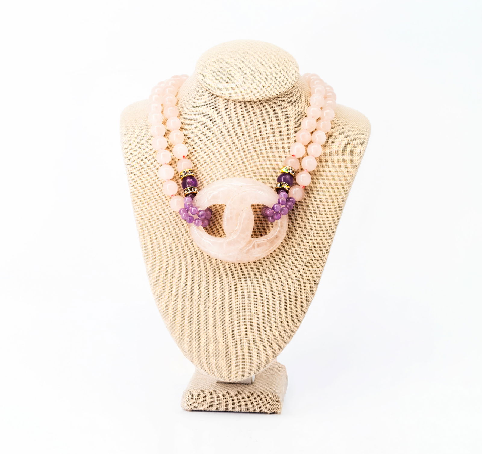 Pink Quartz and Amethyst Beaded Necklace: Title: Pink Quartz and Amethyst Beaded NecklaceMaterial: Pink quartz, amethystDimensions: Length: 15 inDescription: Beaded necklace composed of polished pink quartz beads, accented with amethyst bead