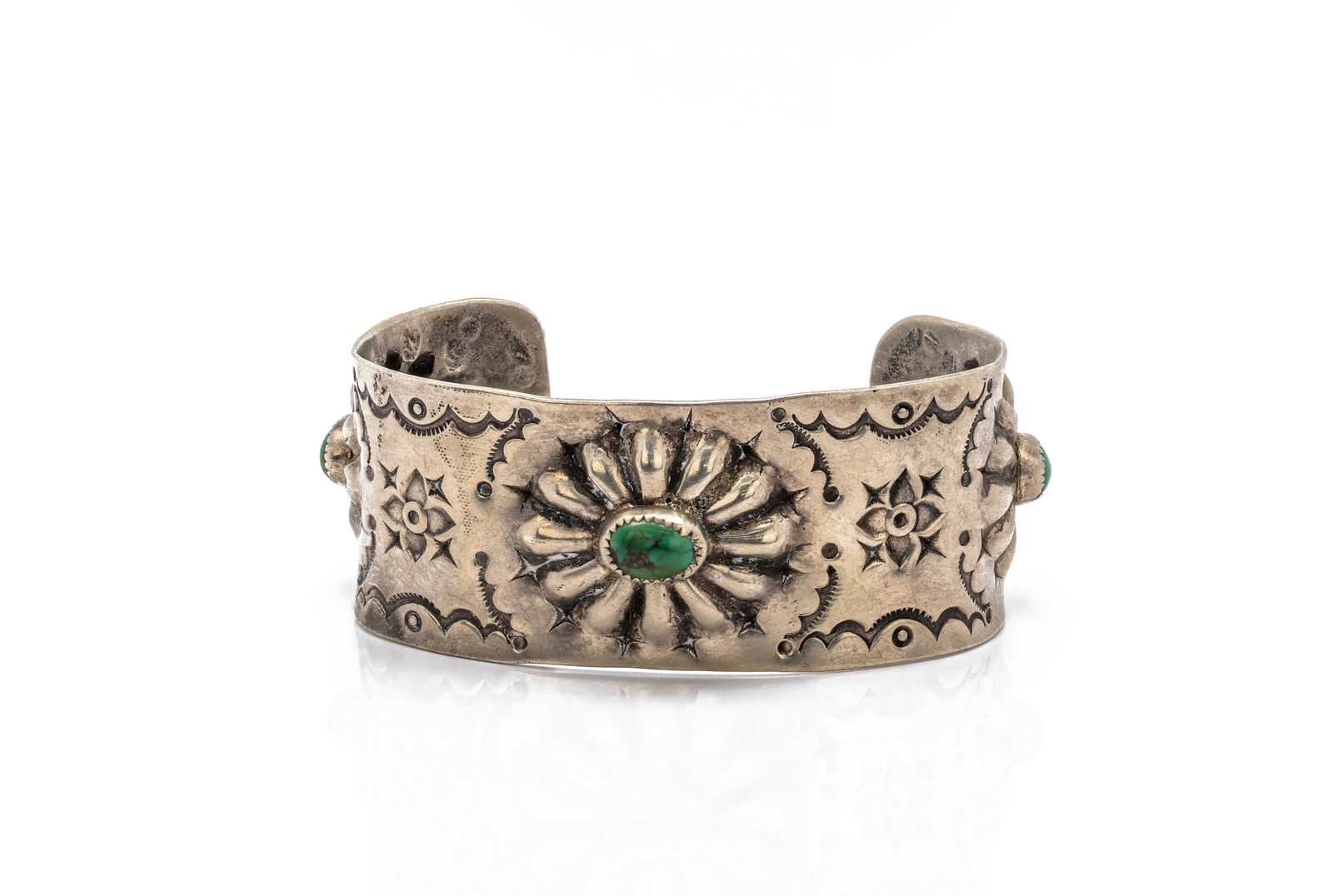 Navajo Stamped Turquoise Silver Cuff Bracelet: Title: Navajo Stamped Turquoise Silver Cuff BraceletOrigin: Native American, NavajoMaterial: Sterling silver with natural turquoise cabochonsSize: 6 3/4Weight: 43.06 gDescription: Wide handcrafted