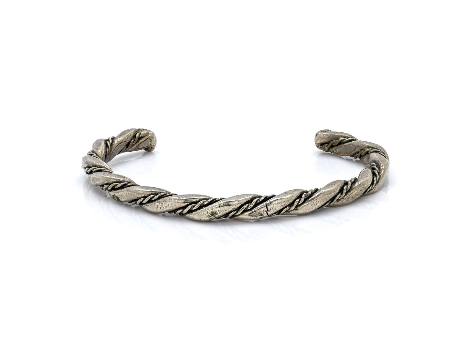 Navajo Twisted Silver Cuff Bracelet: Title: Navajo Twisted Silver Cuff BraceletOrigin: Native American, NavajoMaterial: Sterling silverSize: 7 1/4Weight: 25.19 gDescription: Handcrafted Navajo sterling silver cuff bracelet featuring a
