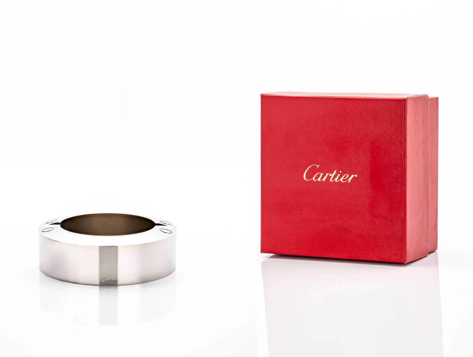 Cartier Stainless Steel Ashtray with Gold Screw Accents in Original Box: Title:Cartier Stainless Steel Ashtray with Gold Screw Accents — in Original Red Cartier Box Brand / Maker: Cartier, Paris Period / Year: Contemporary Origin: