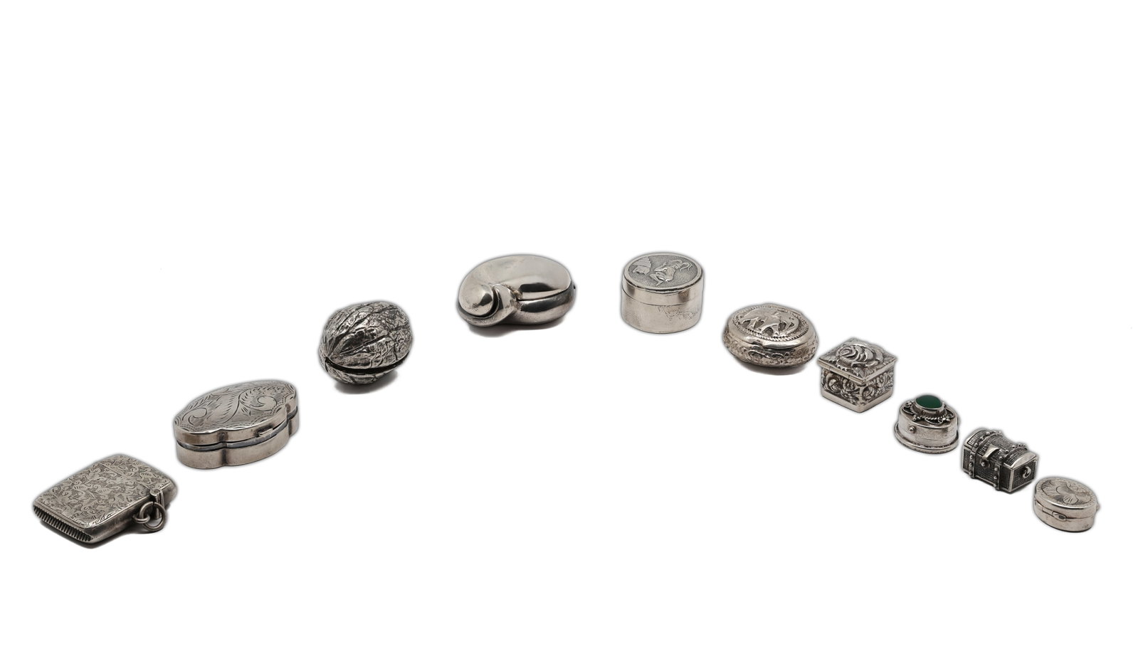 Collection of 10 Sterling Silver Miniature Novelty Boxes: Title: Collection of 10 Sterling Silver Miniature Novelty Boxes Circa: Mid to Late 20th Century Material: Sterling silver, one example set with a green cabochon stone Mar