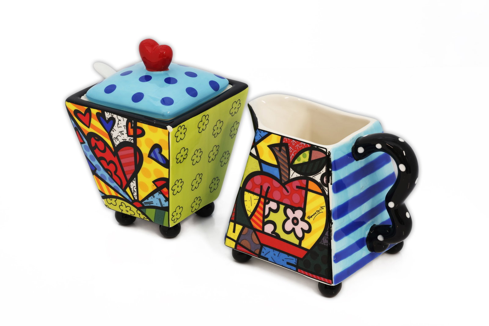 Romero Britto Flying Hearts Ceramic Creamer & Sugar Set: Title: Romero Britto Flying Hearts Ceramic Creamer & Sugar Set Circa: 2008. Manufacturer: Giftcraft Material: Glazed ceramic Origin: Made