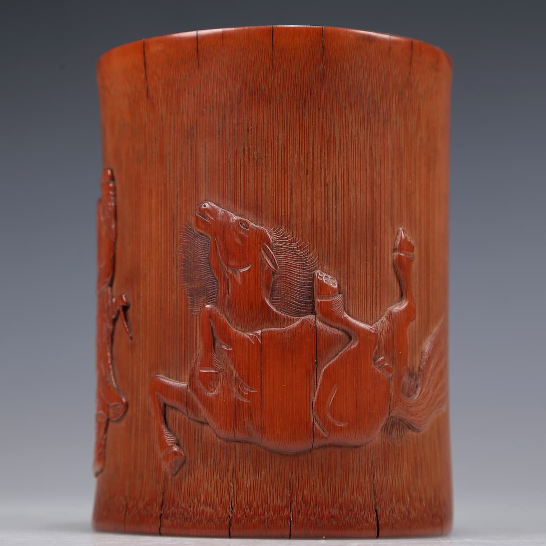 A Brilliant Bamboo 'Horse' Brush Pot: A Brilliant Bamboo 'Horse' Brush Pot. Of a cylindrical shape, the exterior carved with a horse and a figure, body rendered clad in long, flowing robes, the voluminous drapery elegantly cascading in fo