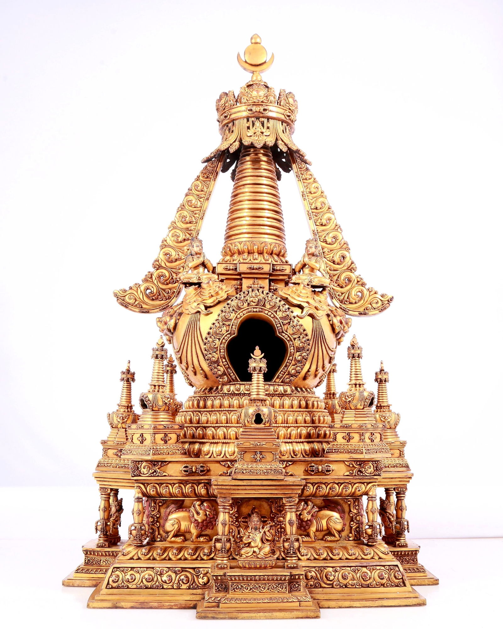 A Magnificent Gilt-Bronze Buddhist Shrine: A Magnificent Gilt-Bronze Buddhist Shrine. Cast with a miniature seated figure, body rendered clad in long, flowing robes, the voluminous drapery elegantly cascading in folds, also playing a lute-like