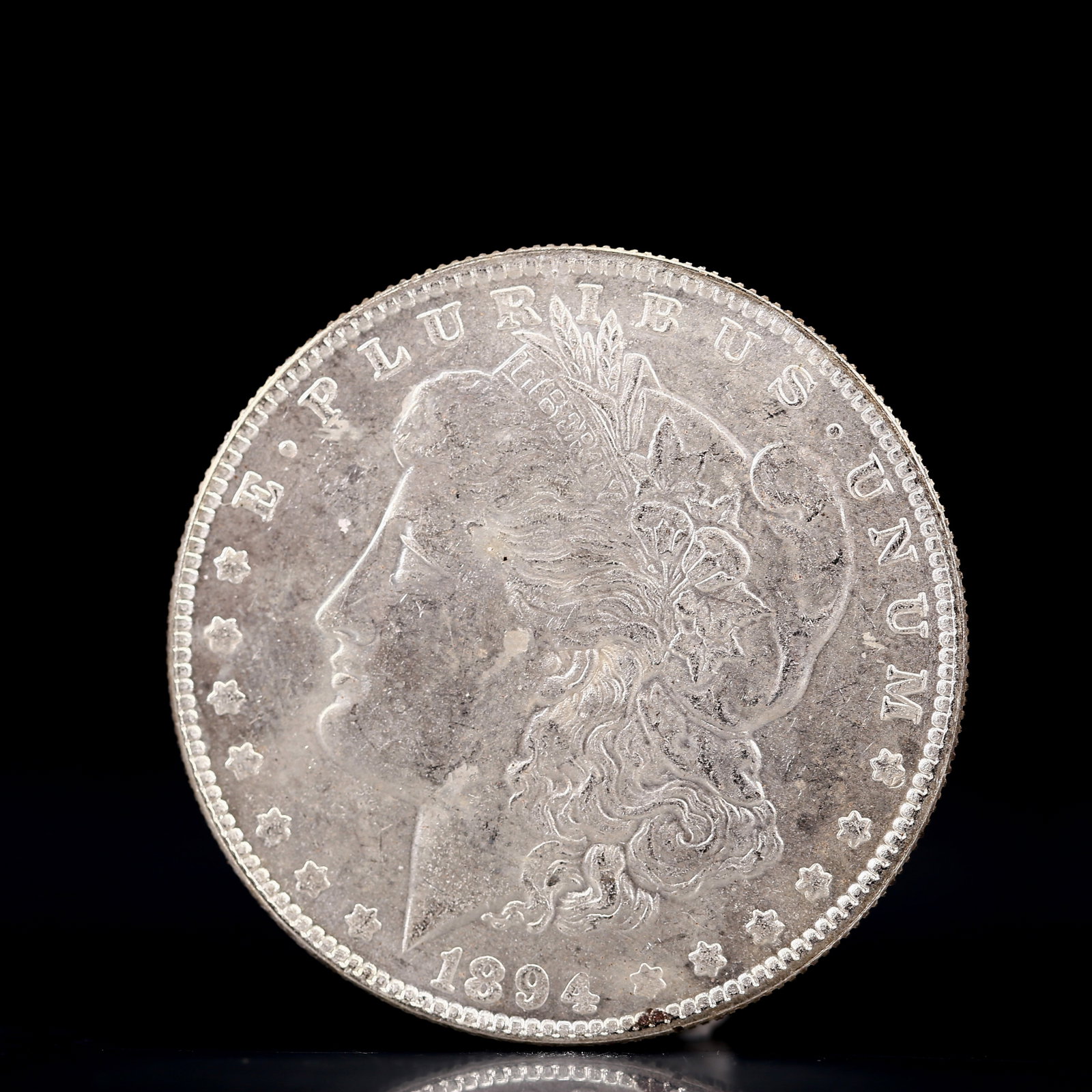 USA Morgan Dollar 1894 Coin: Obv: profile bust with date below and E PLURIBUS UNUM legend and stars around. Rev: eagle with In God we trust above within wreath with UNITED STATES OF AMERICA ONE DOLLAR legend. IN GOD WE TRUST / LI