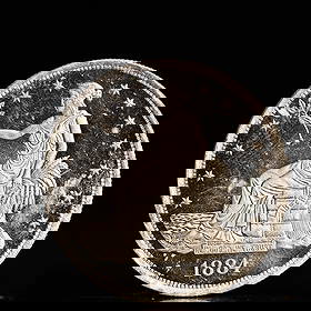 USA Trade Dollar 1884 Coin: American coin. Obverse: Liberty seated on a pedestal facing the sea to the left holding olive branches surrounded by 13 stars. IN GOD WE TRUST / LIBERTY / 1884. Reverse: An eagle holding branches with