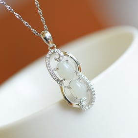 An Exquisite Silver Inlaid White Jade Pendant