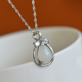 An Exquisite Silver Inlaid White Jade Pendant