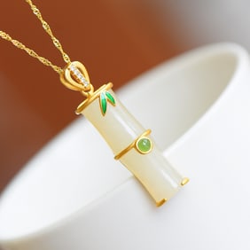 An Exquisite Gilt Silver Inlaid White Jade Pendant