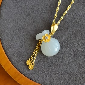 An Exquisite Gilt Silver Inlaid White Jade Pendant