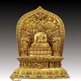 A solemn gilt bronze statue of Gautama Buddha inlaid with precious stones