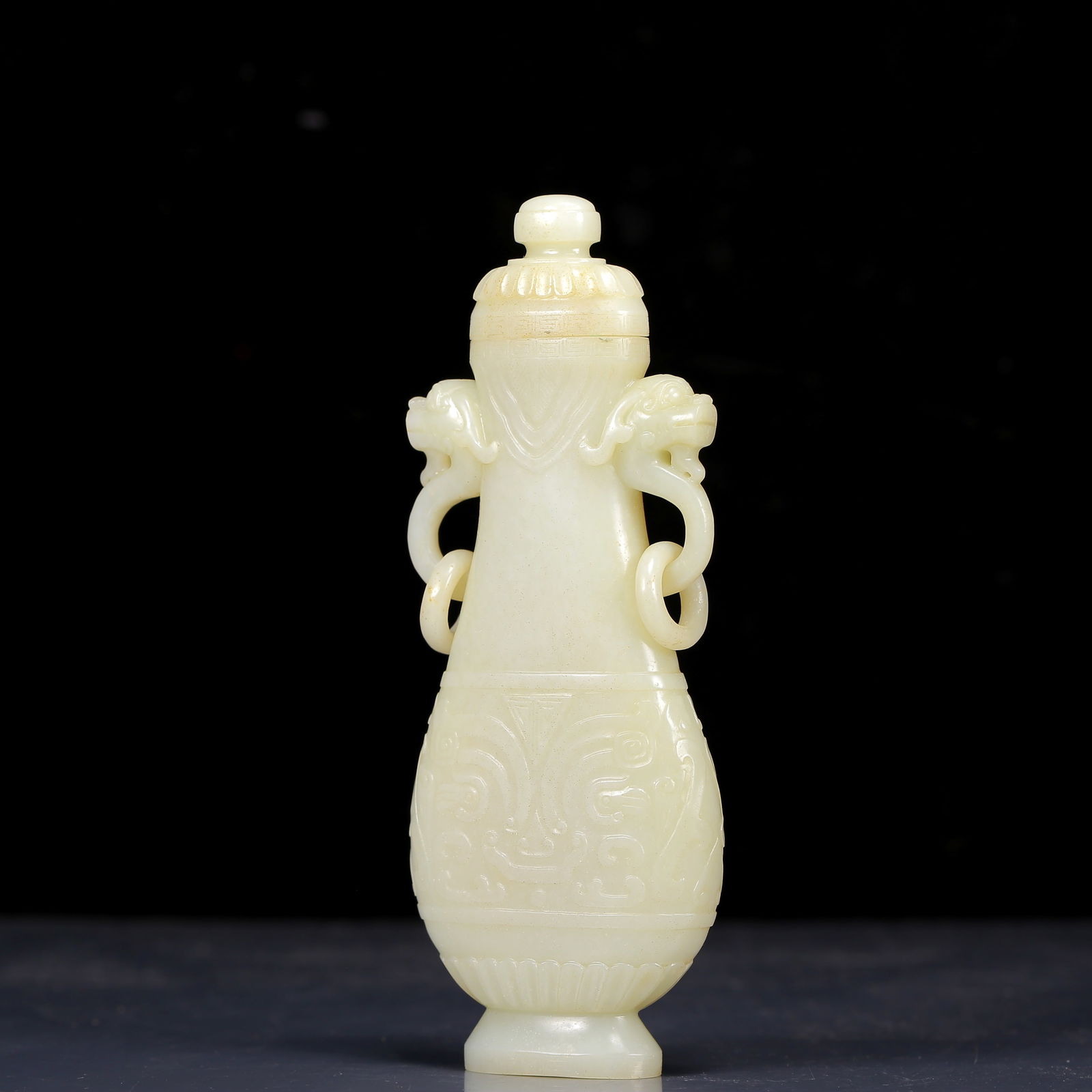 An Exquisite White Jade Beast-Face Pattern Double-Ears Bottle: An Exquisite White Jade Beast-Face Pattern Double-Ears Bottle,Qing Dynasty, China,Size:7.5cmx2.5cmx18.5cm,Weight:325g 白玉兽面纹双耳瓶带盖&#