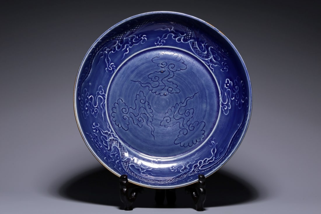 A Rare Blue Glazed Carved Dragon Pattern Plate: A Rare Blue Glazed Carved Dragon Pattern Plate,Qing Dynasty, China,Size:9.4inx2in,Weight:934g 外酱釉内蓝釉刻龙纹盘,中国清&