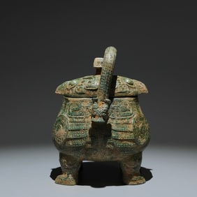 An Archaic Bronze Owl Pattern Loop-handled Pot