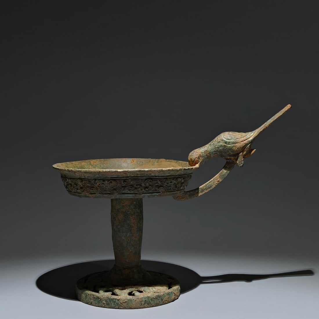 An Archaic Bronze Bird Pattern Candlestick,with Inscription: An Archaic Bronze Bird Pattern Candlestick,with Inscription,The Warring States Period in China,Size:9.4inx12.2inx7.5in 青铜鸟纹烛台,带铭文,中