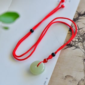 An Exquisite Greenish Jade Pendant