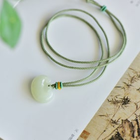 An Exquisite Greenish Jade Pendant