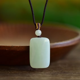 An Exquisite Greenish Jade Pendant